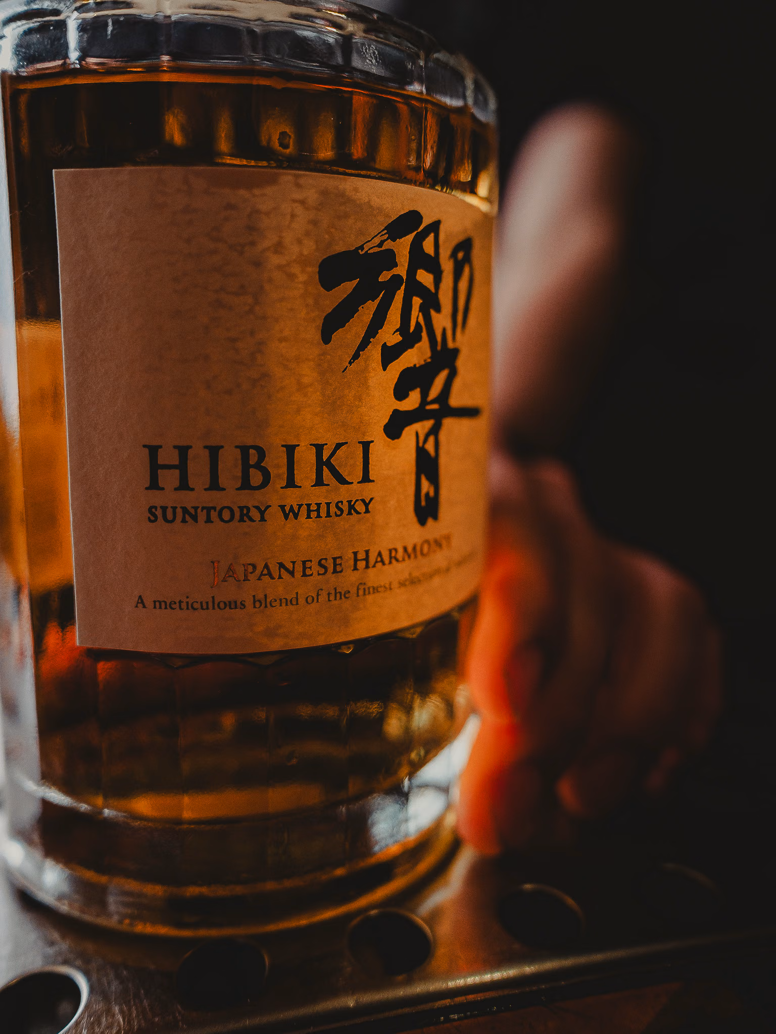 Bottle of Hibiki Suntory Whisky held over the bar at Panda & Sons, Edinburgh